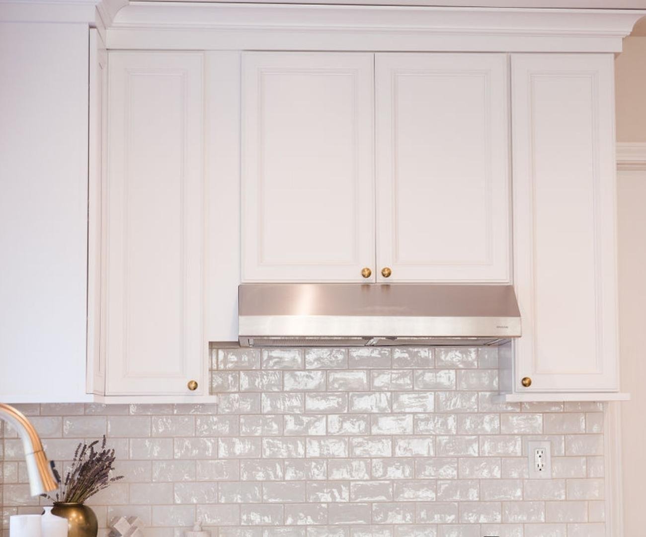 Image of Full-height white kitchen cabinetry with brass hardware and subway tile backsplash in West Bloomfield, MI Image of Full-height white kitchen cabinetry with brass hardware and subway tile backsplash in West Bloomfield, MI