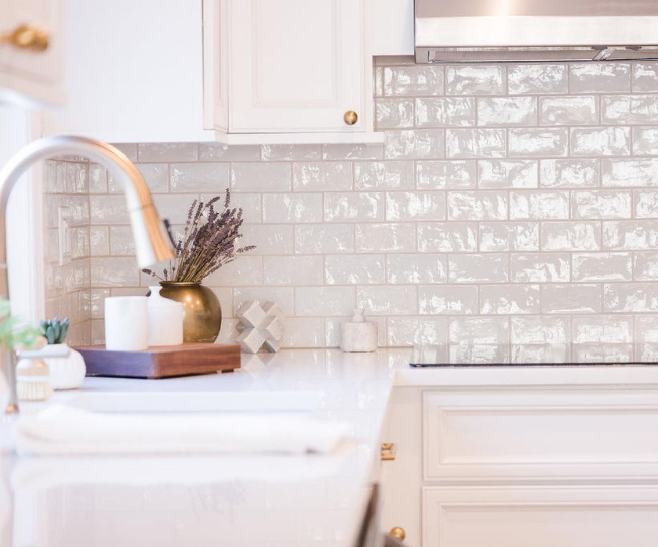 Image of White kitchen backsplash and cabinetry with gold accents in Kitchen Remodel in West Bloomfield, MI