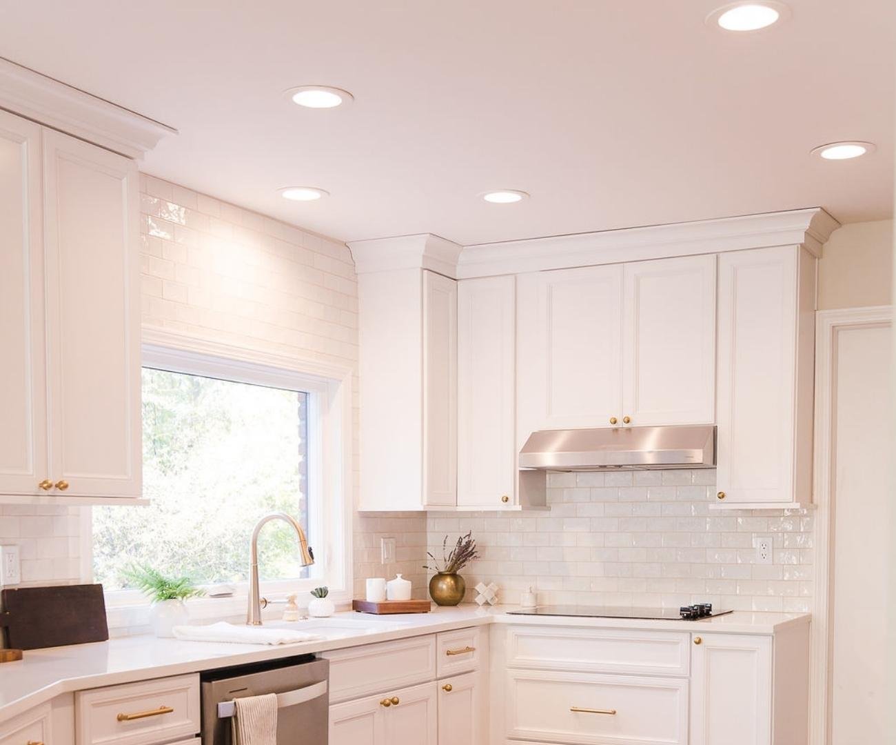 Photo of bright white kitchen remodel with subway tile backsplash in West Bloomfield, MI by Cabinet Creations