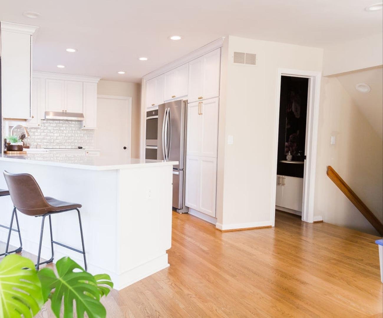 Photo of open-concept kitchen remodel with white island and cabinetry in West Bloomfield, MI by Cabinet Creations