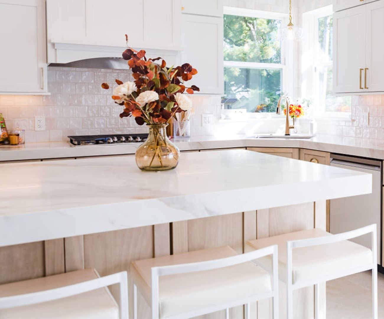 Bright kitchen remodel with a large marble island that comfortably fits three bar seats by Cabinet Creations in White Lake Township, MI Bright kitchen remodel with a large marble island that comfortably fits three bar seats by Cabinet Creations in White Lake Township, MI