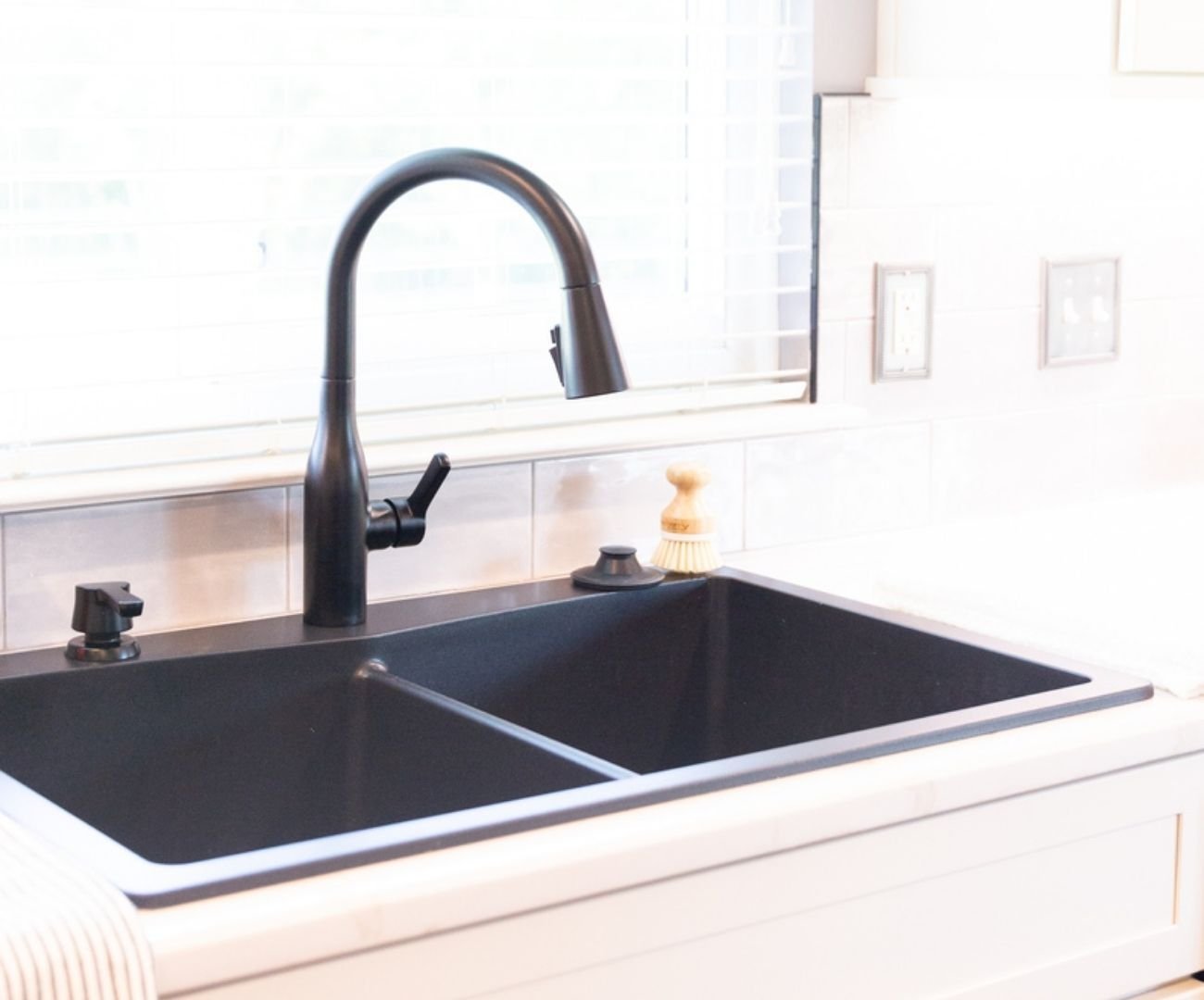 Stylish kitchen remodel with contemporary black sink and shaker cabinetry by Cabinet Creations in Michigan