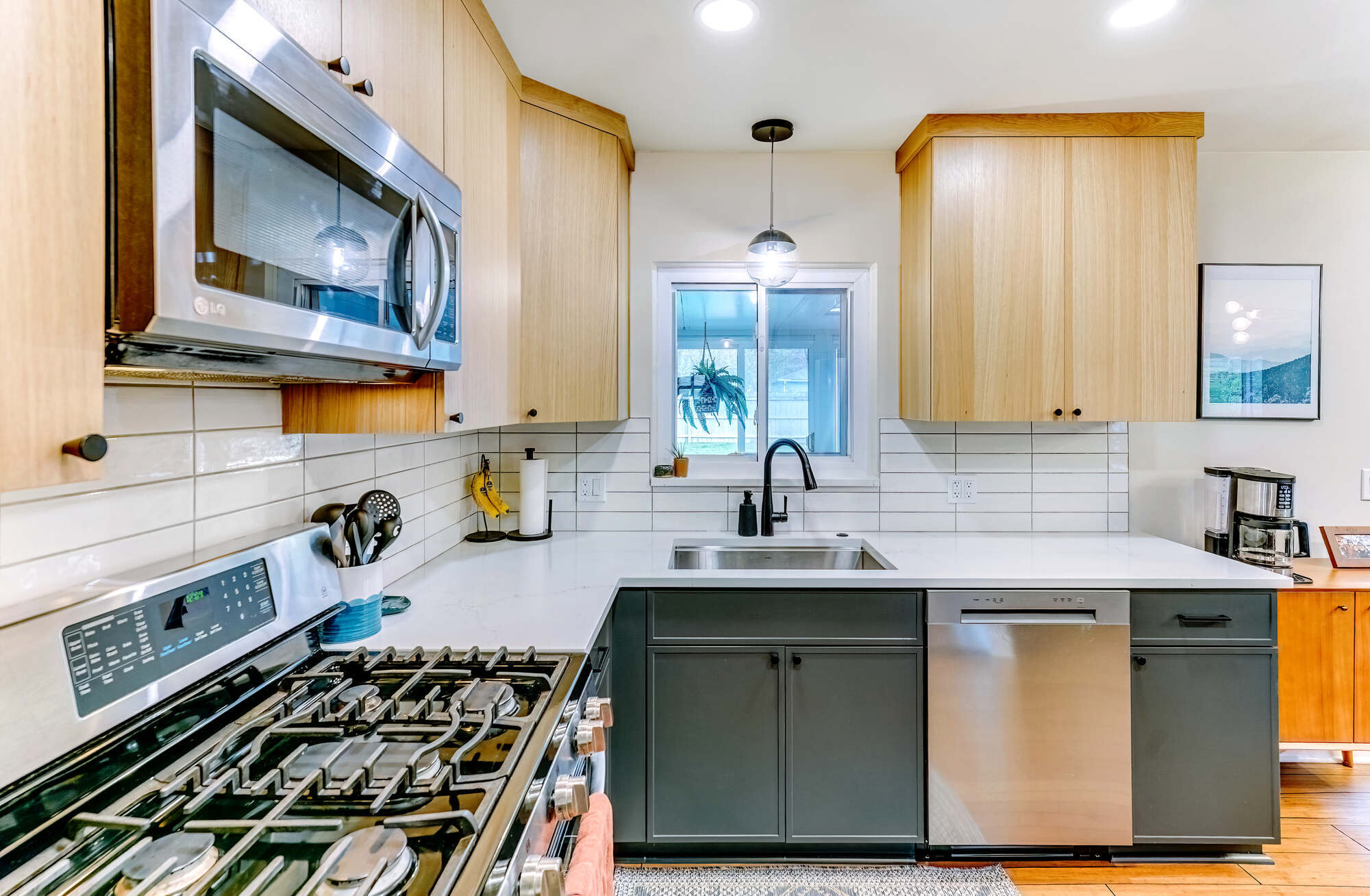 Waterford Township custom kitchen highlighting clean lines, upper wood cabinetry, and lower dark cabinets by Cabinet Creations