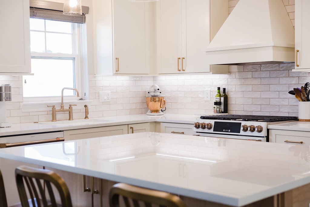 Bright kitchen corner featuring quartz counters and white cabinetry by Cabinet Creations in Michigan
