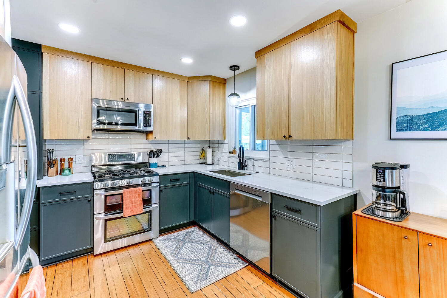 Custom kitchen with clean lines, light wood cabinets, and white countertops by Cabinet Creations in Waterford Township, MI
