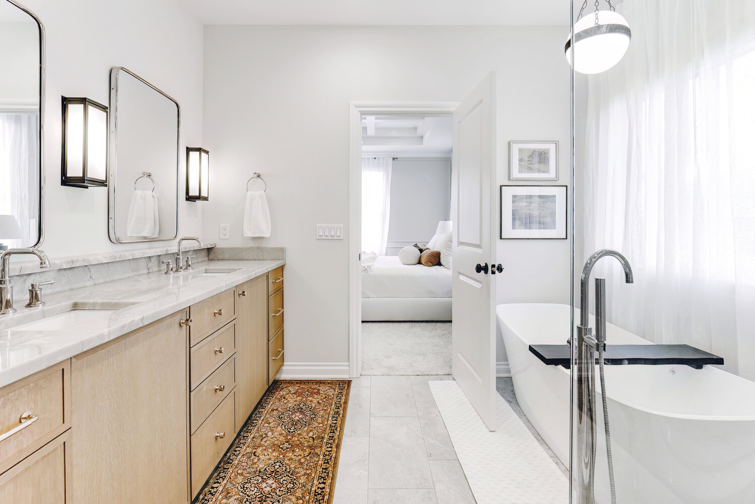 Custom master bathroom layout with soaking tub, modern vanity, and entry to bedroom in Waterford Township, MI