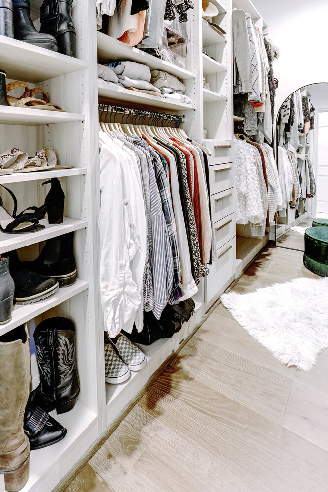 Stylish and functional closet design with soft lighting and bench seating by Cabinet Creations in Royal Oak, MI