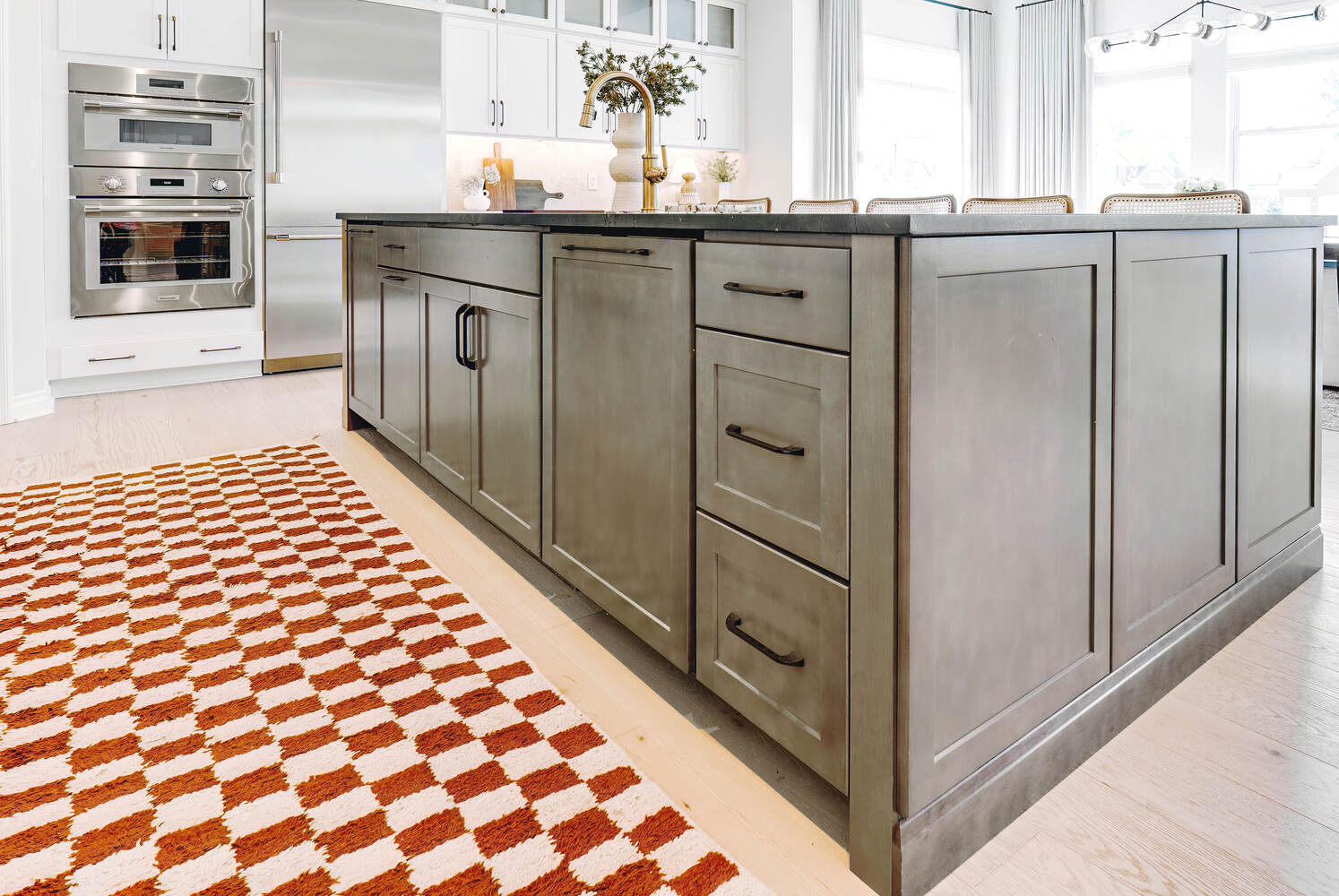 Kitchen island with wood cabinetry and stainless steel appliances by Cabinet Creations in Oakland County, MI