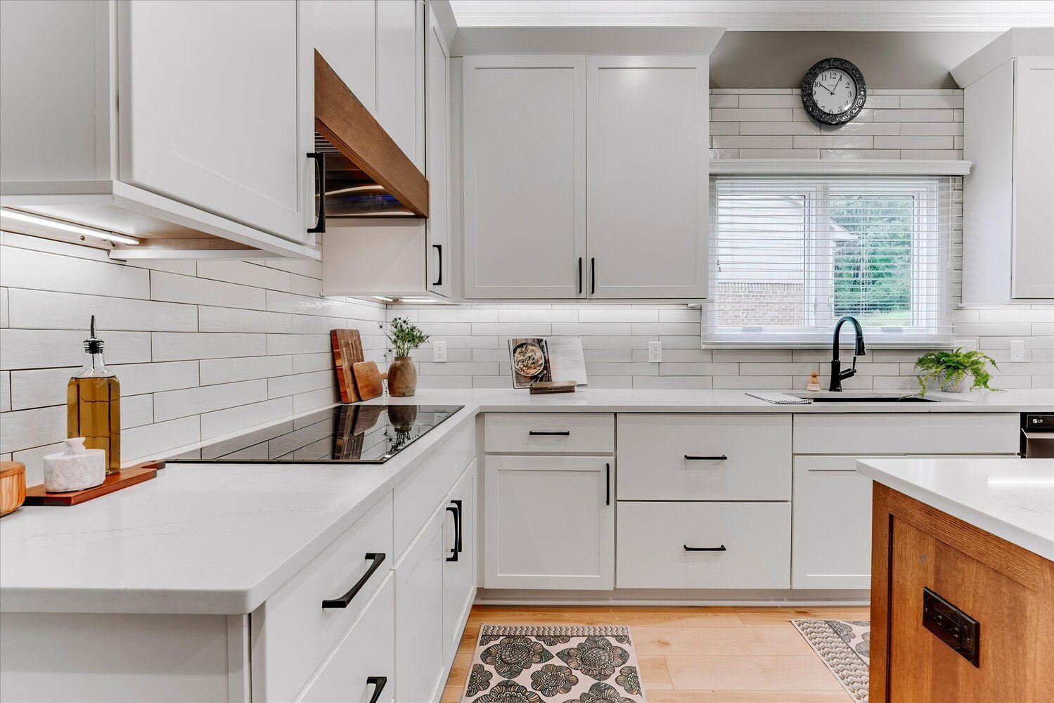 White shaker cabinets and quartz countertops in a custom kitchen by Cabinet Creations in Oakland County, MI