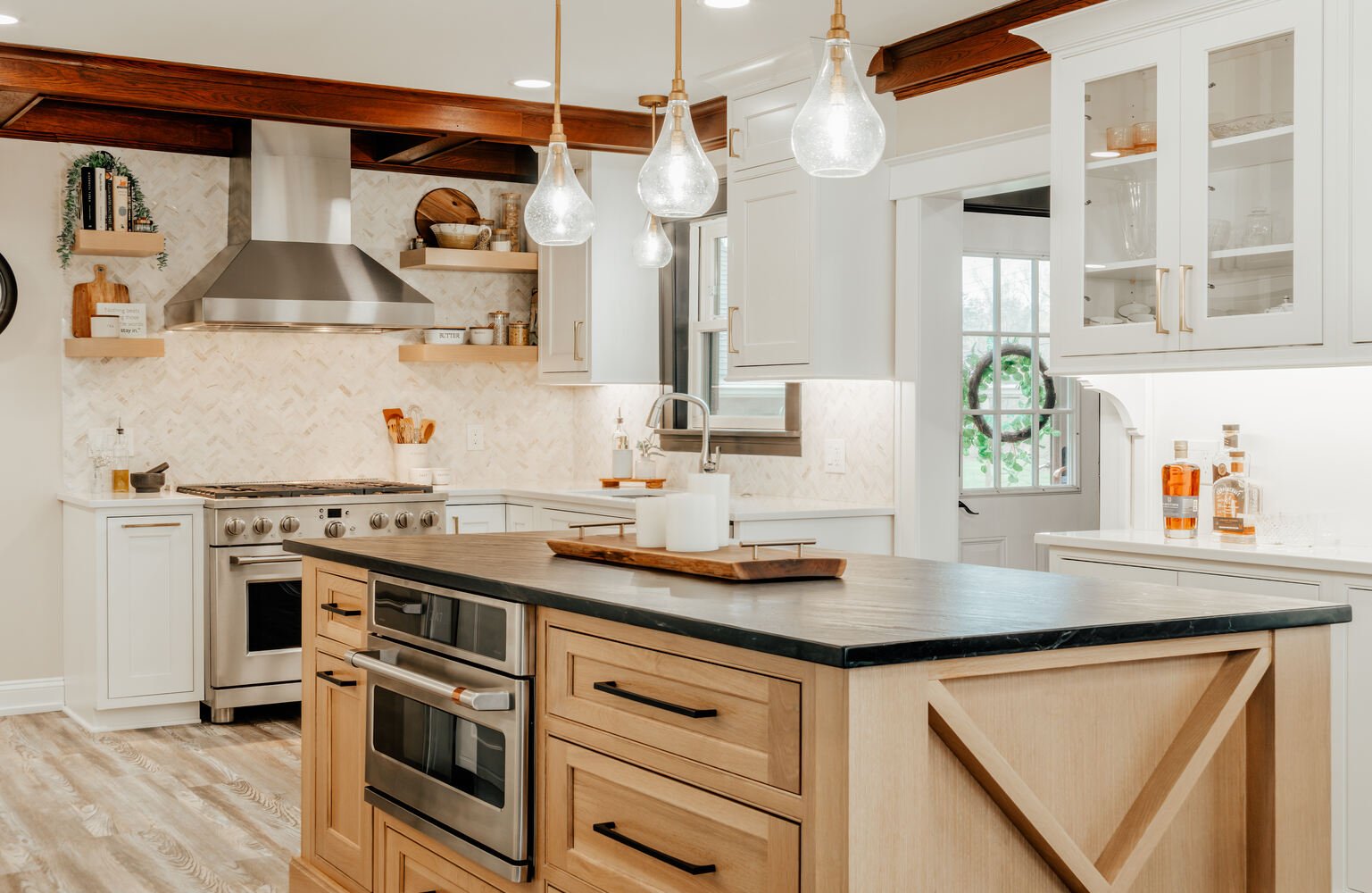 Elegant transitional kitchen design in Lake Orion, Michigan with wood island and pendant lighting by Cabinet Creations