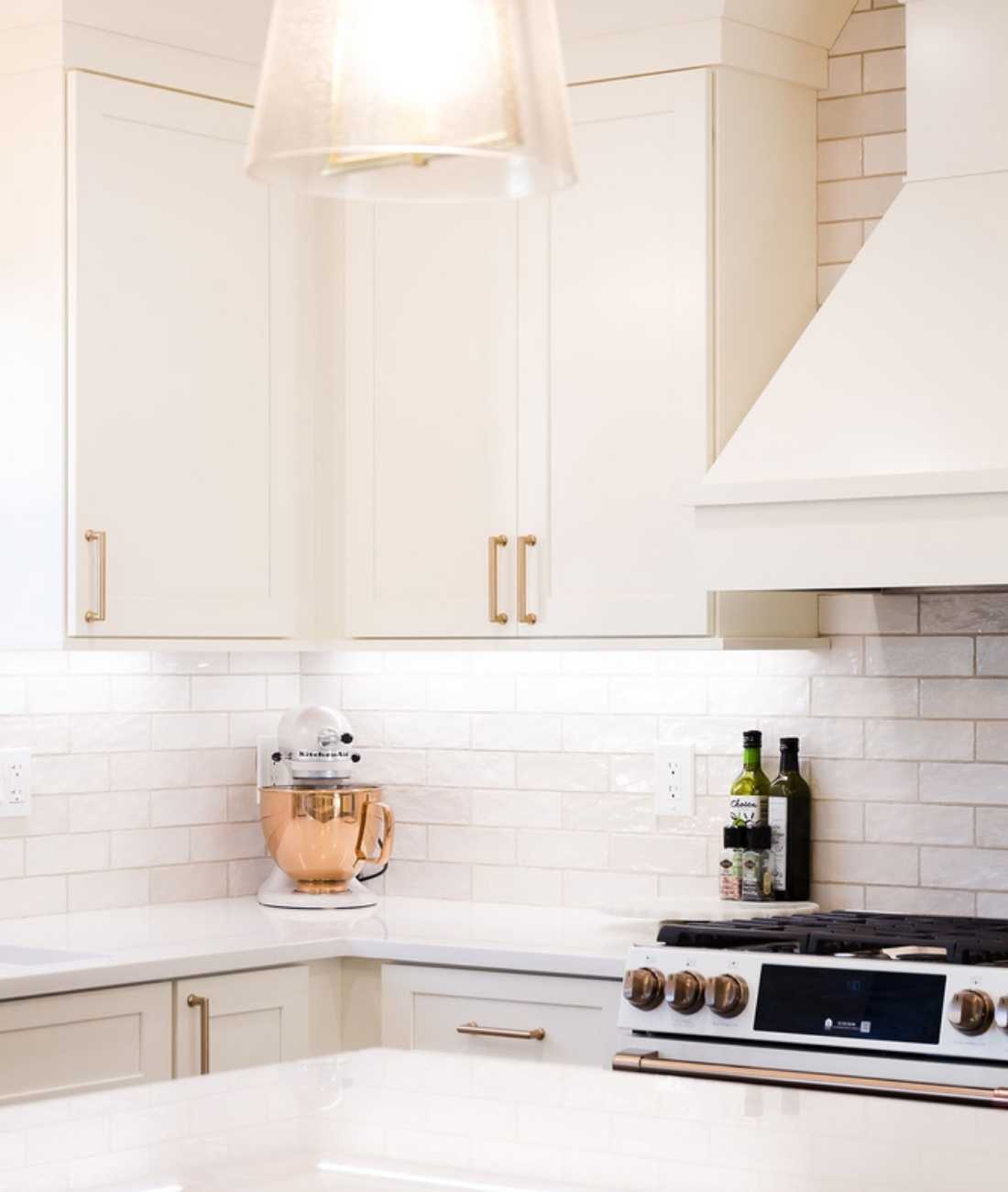 Modern white kitchen corner with quartz counters and custom cabinetry by Cabinet Creations in Michigan