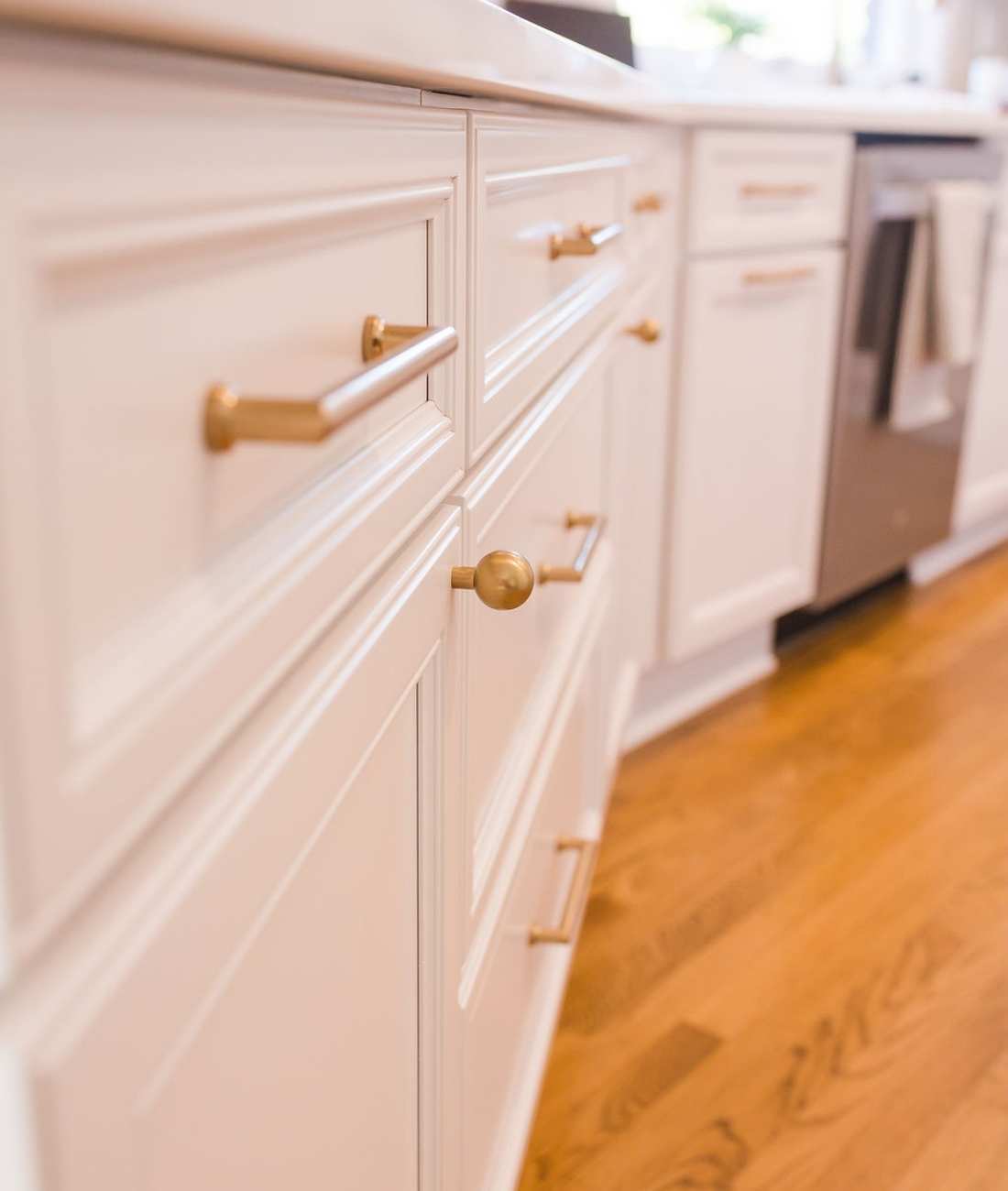 Photo of white kitchen cabinetry with brass hardware in West Bloomfield, MI by Cabinet Creations
