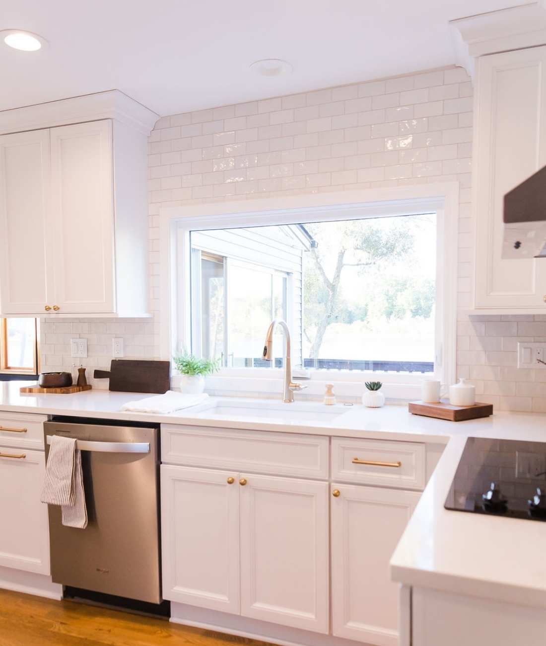 Photo of white kitchen remodel with farmhouse sink and subway tile in West Bloomfield, MI by Cabinet Creations