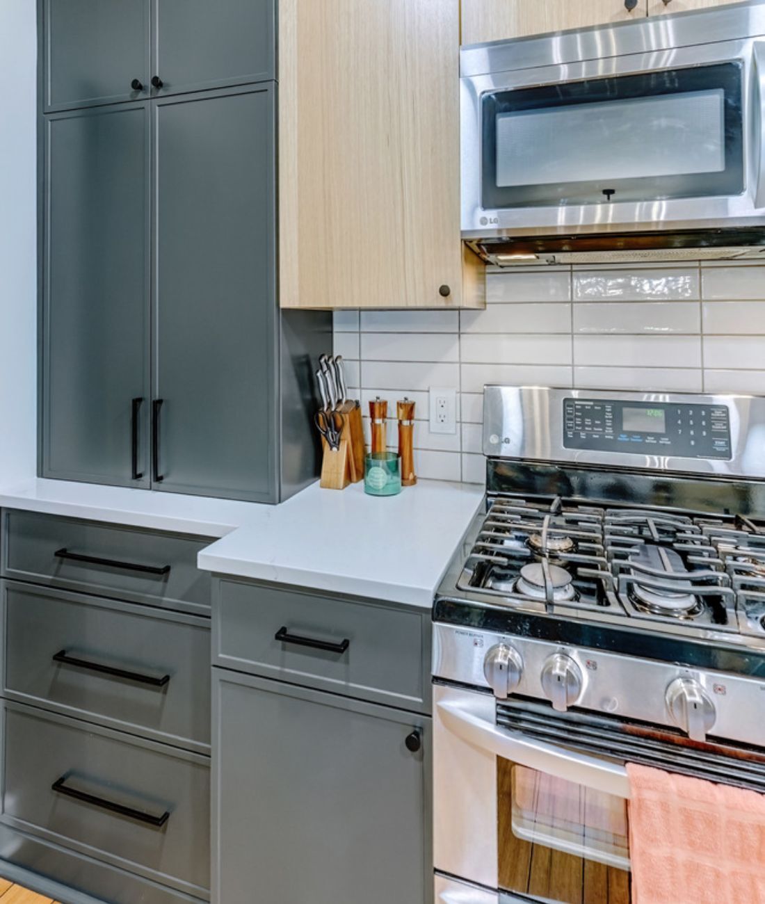 Custom kitchen in Clarkston, MI featuring black hardware and natural wood details by Cabinet Creations