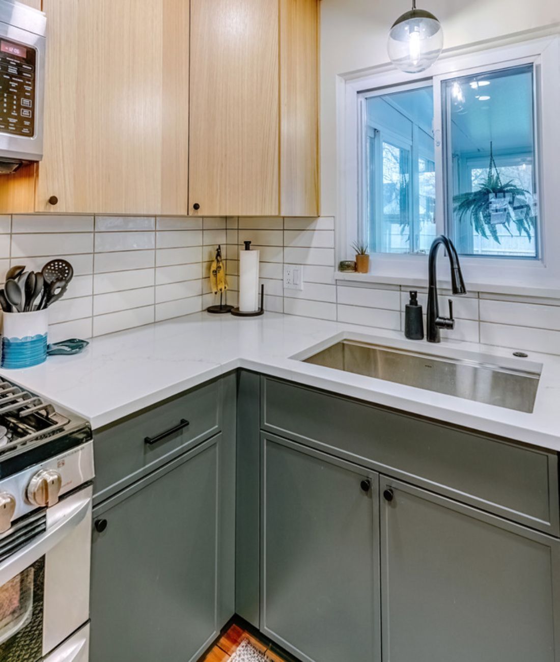 Kitchen sink corner with matte gray base cabinets and white quartz counters in Clarkston, MI by Cabinet Creations