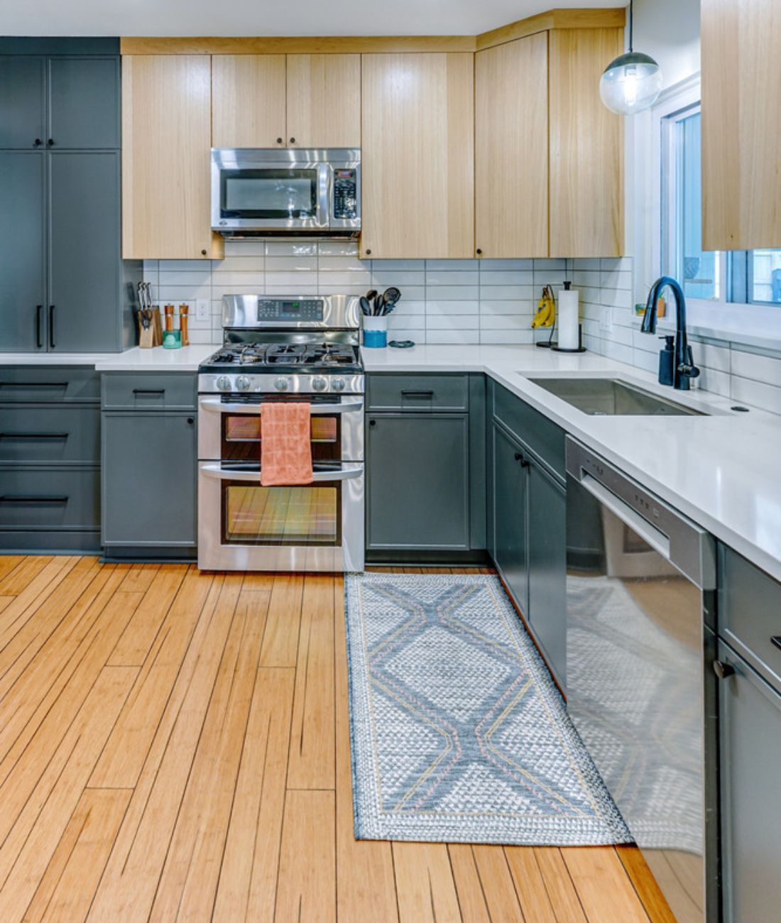 Modern U-shaped kitchen layout with bold two-tone cabinets by Cabinet Creations in Clarkston, MI