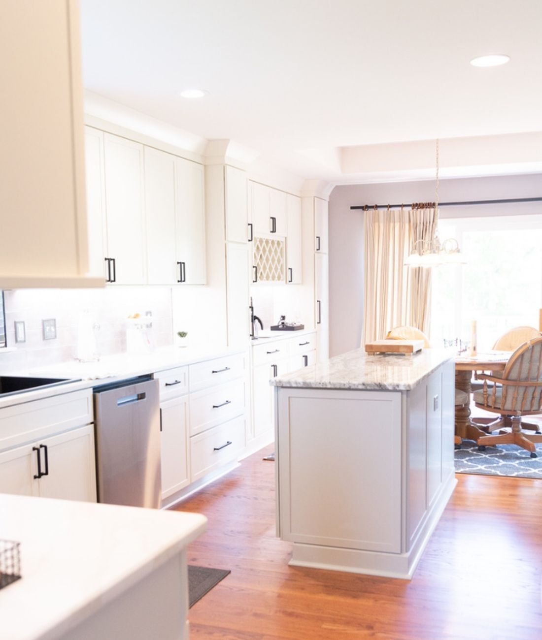 Spacious custom kitchen with center island and white cabinets by Cabinet Creations in White Lake, Michigan